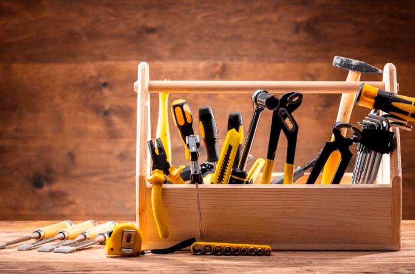 Daily tools including a multitool, notebook, and phone charger.